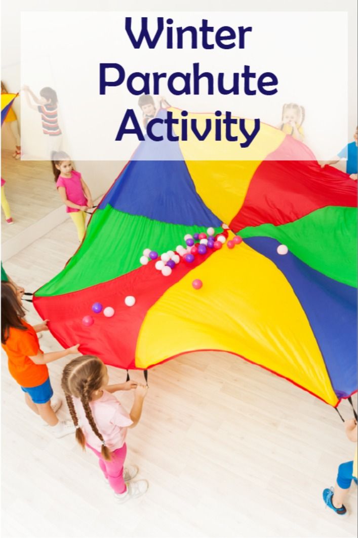 children are playing with a large kite in the middle of a room that says winter parachute activity