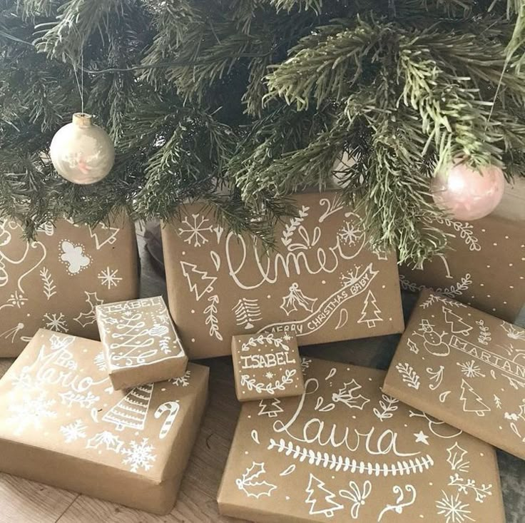 christmas presents under the tree with handwritten words on them