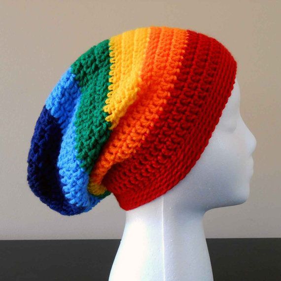 a white mannequin head wearing a multicolored knitted hat