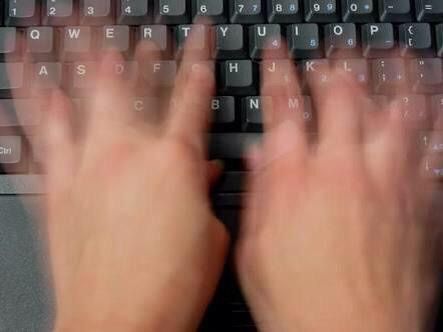 someone typing on a computer keyboard with their hands over the top of the key board