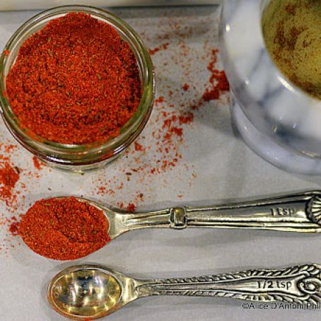 three spoons are sitting on a table next to some spices and seasoning powder