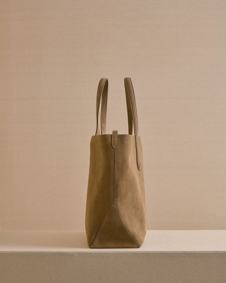 The Eleanor Tote is the perfect slouchy, easy tote bag. Crafted from the softest Calfskin suede in Mushroom with tonal stitching, the Eleanor Tote features a third strap which fastens using our signature collar studs. Easy Tote Bag, Slouchy Tote, Travel Scarf, Mark Cross, Rings For Girls, By Grace, Handbag Shoes, Grace Kelly, Rear Window