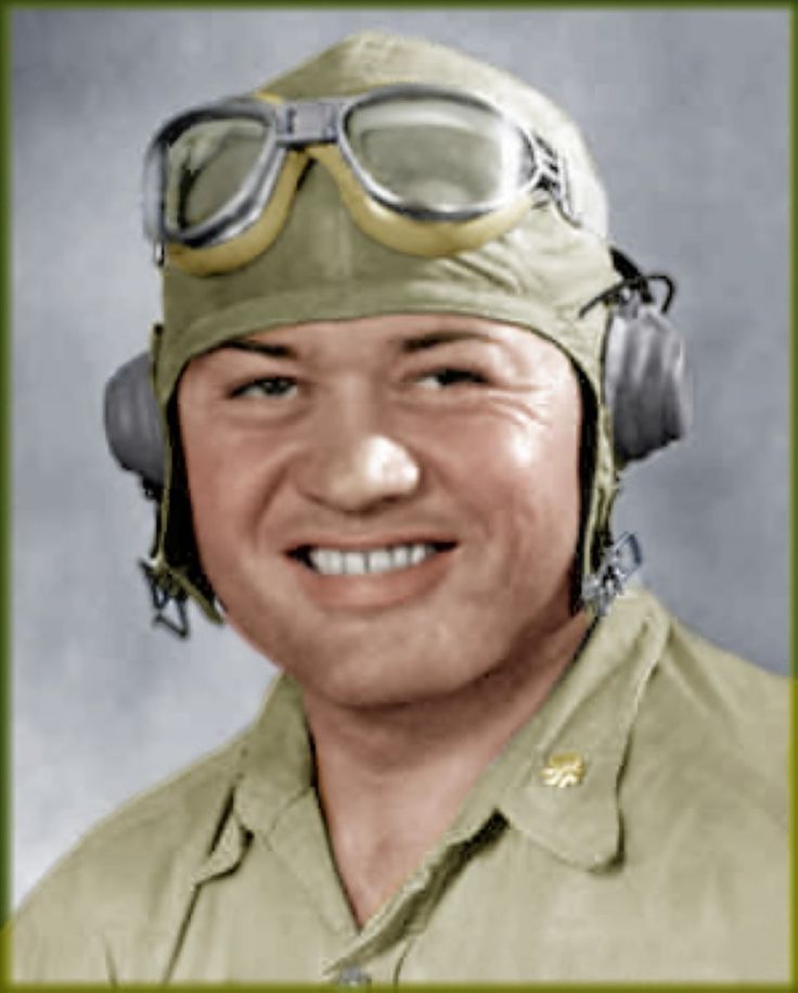 an old photo of a man wearing goggles and a pilot's hat with headphones on