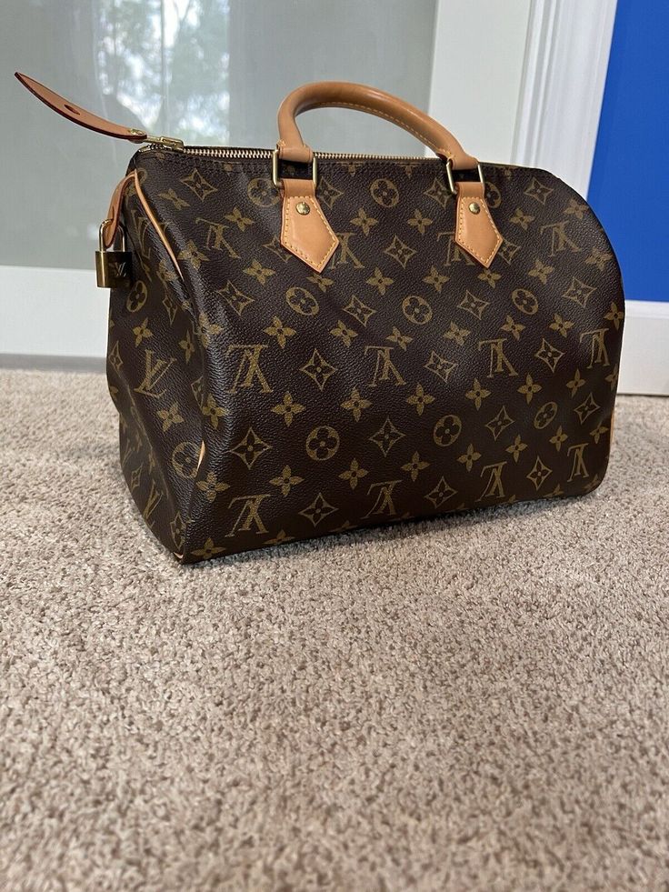 Louis Vuitton Speedy 30 Bag. Classic Louis Vuitton bag perfect for any Louis collection. Bag is big enough to fit all the essentials. No callouts for bag. I don’t have the box or bag it came. Item code: SD1125 Key Lock #310 11.8 x 8.3 x 6.7 inches (length x Height x Width) Monogram coated canvas Natural cowhide-leather trim Textile lining Gold-color hardware Padlock Inside zipped pocket D-ring Handle:Double Louis Vuitton Brown Bag, Louis Vuitton Speedy 30, Ring Handle, Speedy 30, Louis Vuitton Brown, Key Lock, Brown Canvas, Vuitton Bag, Louis Vuitton Speedy