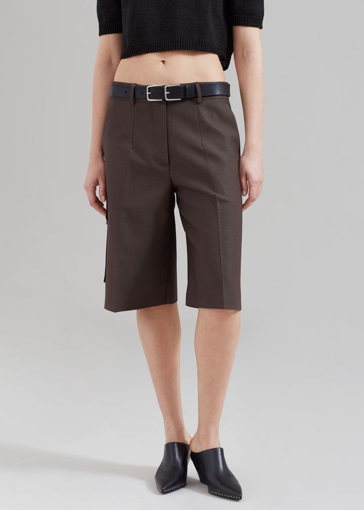 Color: Brown Lightweight fluid fabric Relaxed fit Rests low on the waist Front pleat detailing Belt loops Side seam pockets Cargo pocket detailing Illusion welt back pockets Hook and bar closure Zip fly Unlined 100% Polyester Dry Clean Imported Cargo Shorts, Relaxed Fit, Color