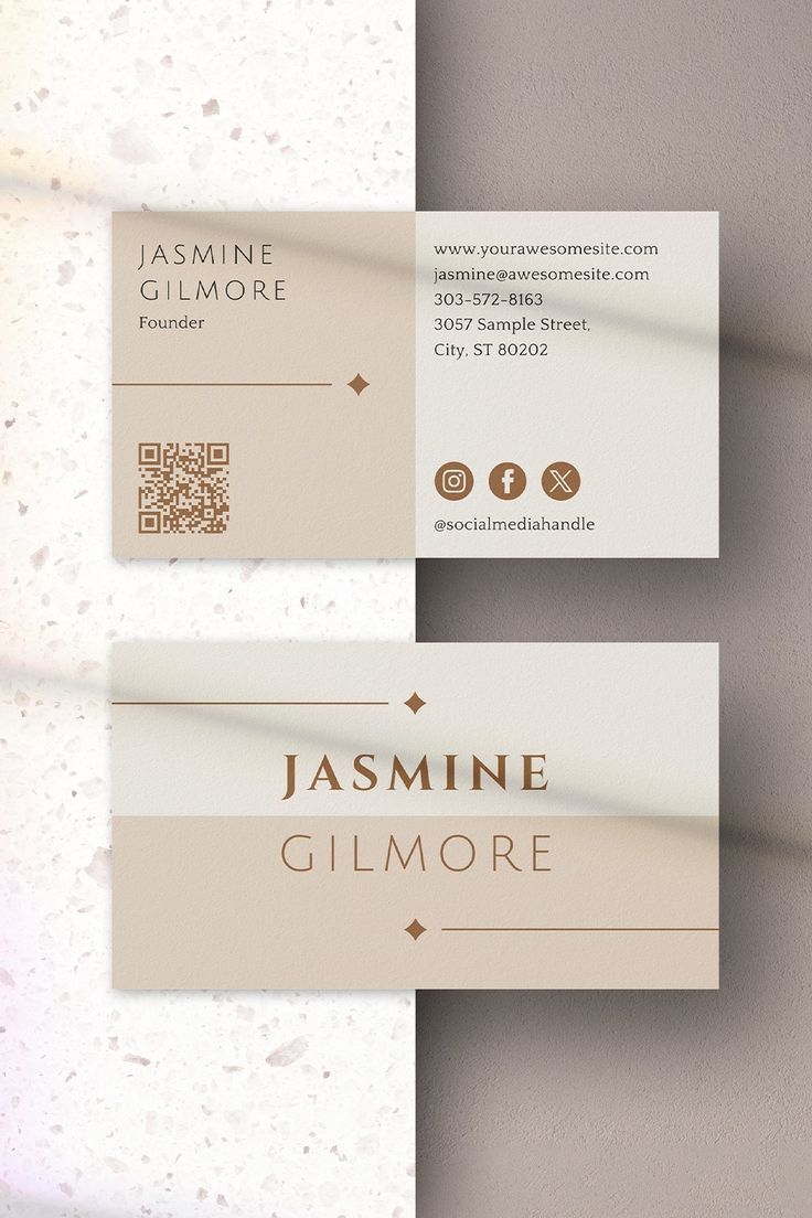 two business cards with gold foil on them, one is white and the other is beige