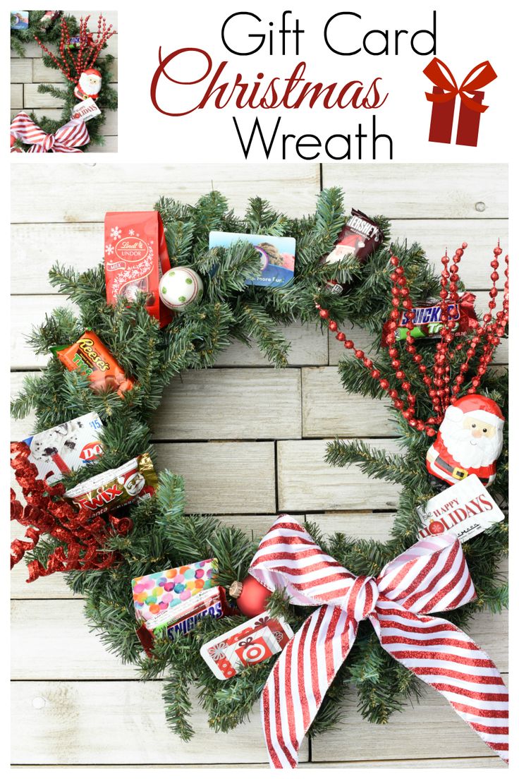 a christmas wreath with candy, candies and other holiday treats on it sitting on a wooden surface