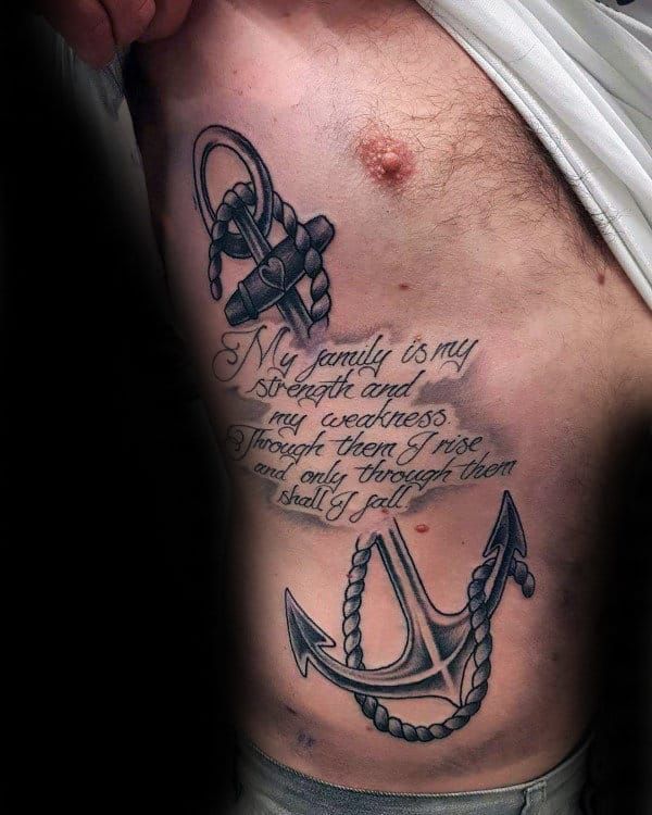 a man's chest with an anchor and quote tattoo on the left side of his stomach