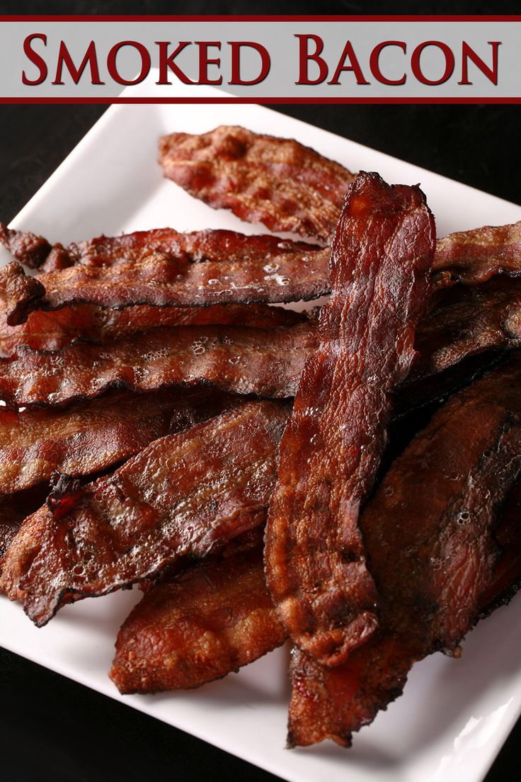 there is a white plate with bacon on it and the words smoked bacon written in red