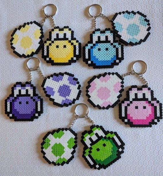 six pixel keychains with different designs on them