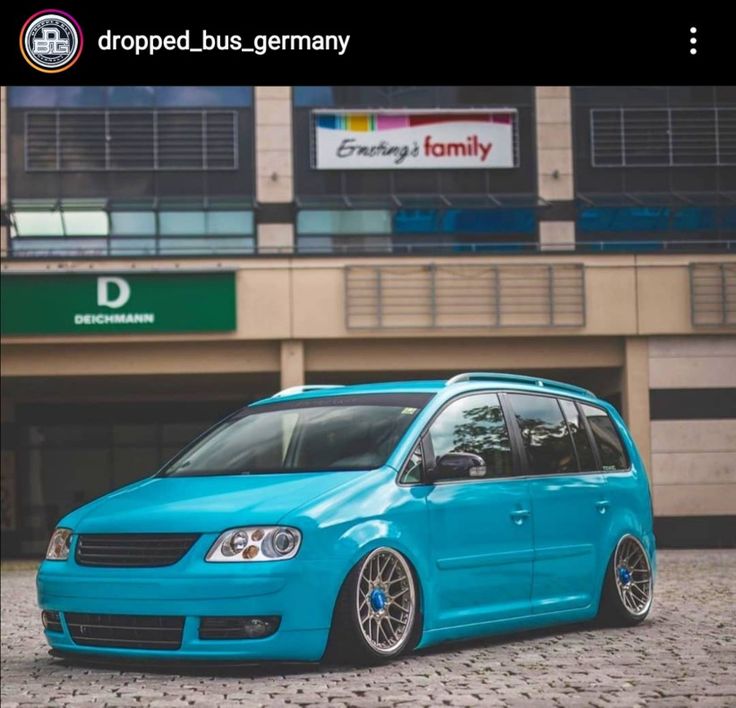 a blue van parked in front of a building