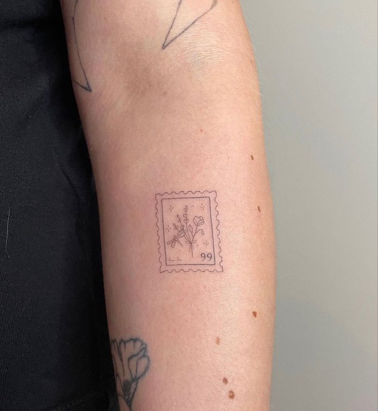 a person with a tattoo on their arm has a small flower in the middle of his arm