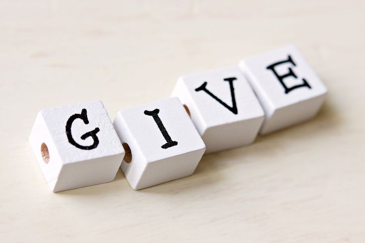 the word give spelled with dices on a table