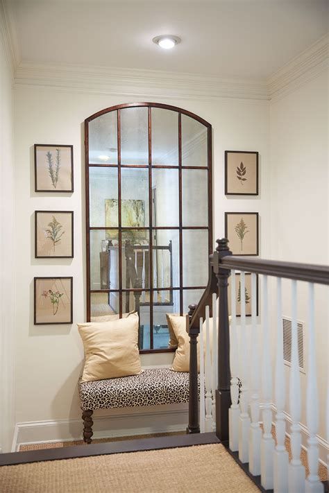 an entry way with a bench and pictures on the wall