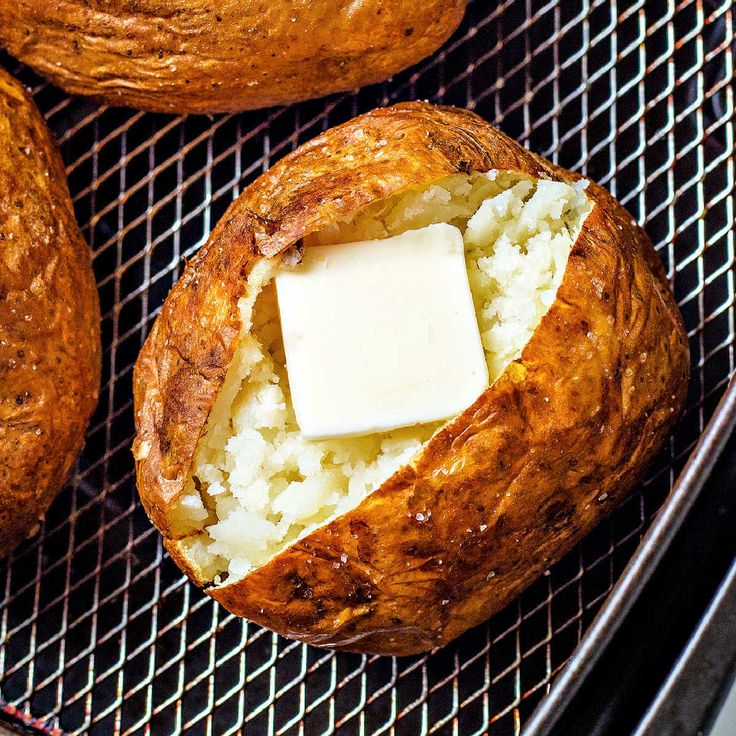 baked bread with butter on top and some sort of cheese in the middle, sitting on a cooling rack