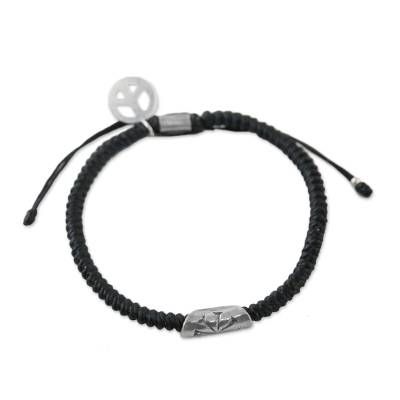 From Thailand's Napapat comes this cord bracelet in an onyx hue. The work of Karen hill tribe artisans the bracelet is expertly braided by hand. It features a cylindrical hand-stamped silver accent with a flower motif and a silver peace symbol charm which both contrast nicely against the dark tone of the bracelet. A sliding knot closure allows for an individualized fit. Everyday Silver Braided Bracelet With Sliding Knot, Adjustable Bohemian Sterling Silver Braided Bracelet, Adjustable Artisan Sterling Silver Beaded Bracelets, Spiritual Silver Friendship Bracelets With Sliding Knot, Adjustable Braided Bracelet Jewelry, Adjustable Braided Jewelry Bracelet, Handmade Silver Braided Bracelets, Handmade Silver Braided Bracelets, Adjustable, Handmade Adjustable Silver Braided Bracelets