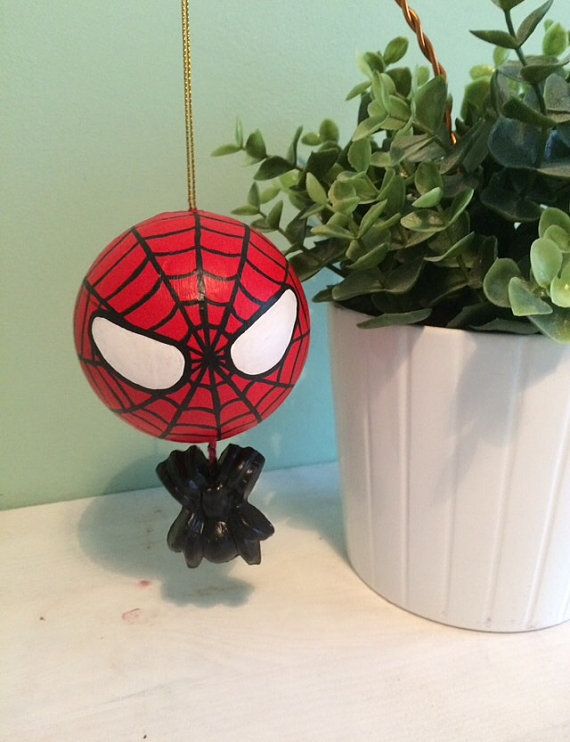 a spider man ornament next to a potted plant