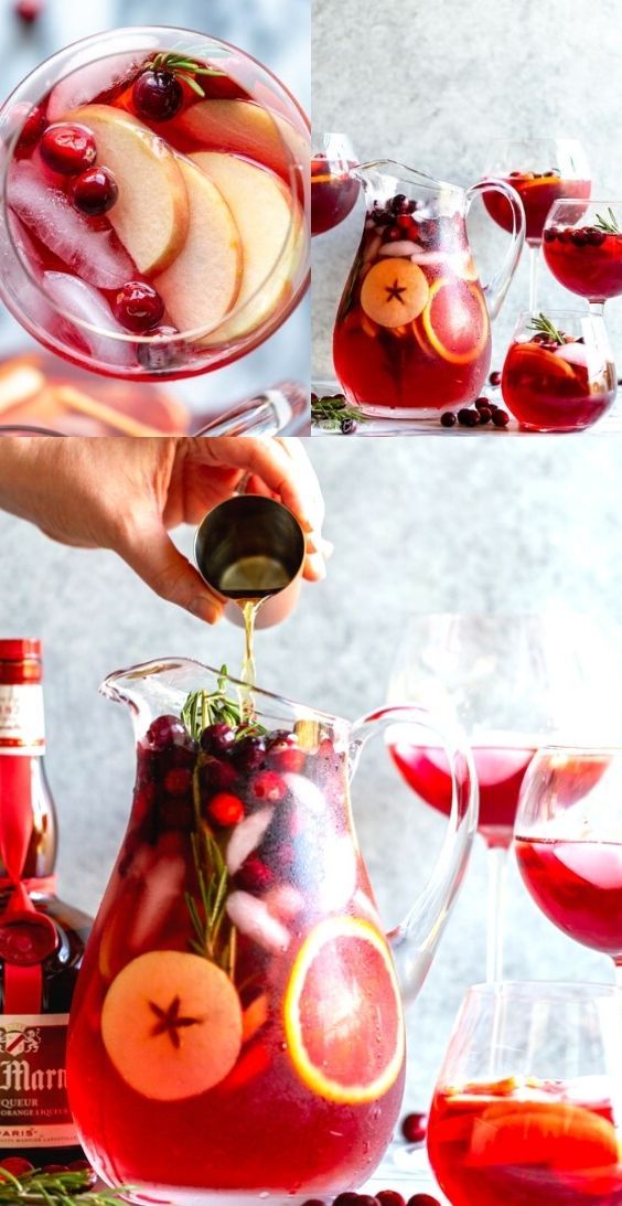 a pitcher filled with red liquid, apples and cranberries