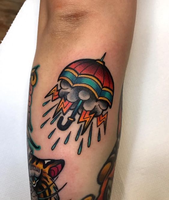 a colorful tattoo on the leg of a man with an octopus and hot air balloon