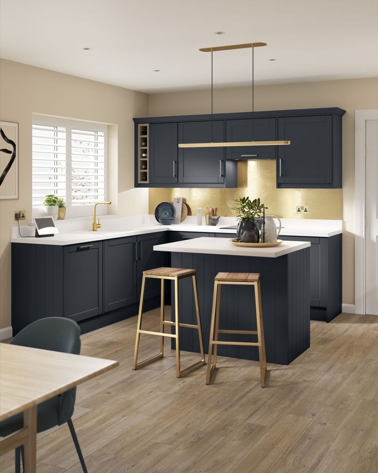 a kitchen with wooden floors and dark blue cabinets, white counter tops and bar stools