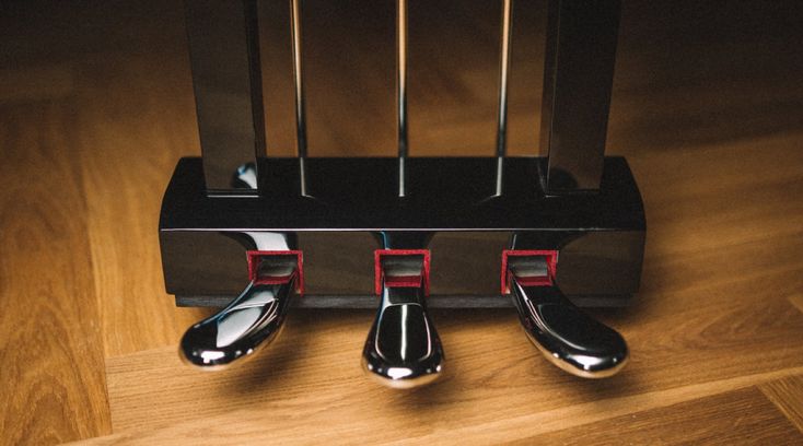 three black and red pieces of luggage sitting on top of a wooden floor