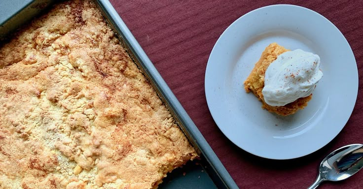 a dessert is sitting on a table next to a plate with a fork and spoon