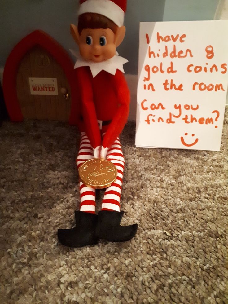 an elf is sitting on the floor next to a sign that says i have hidden 8 gold coins in the room can you find them?