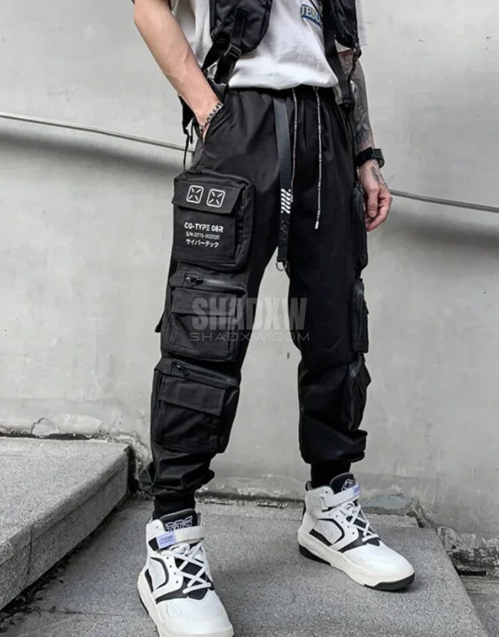 Design: Cyberpunk Technical pants: This techwear pants is the perfect garment to complete your Techwear outfit. Breathable materials: This techwear hoodie made of polyester, cotton and spandex can be worn all year round. Machine washable: 30 °C (86 °F) Cyberpunk techwear pants Crafted for the modern nomad, the Cyberpunk Pants echo the ethos of a dystopian world where fashion meets functionality. The pants are made from high-quality, durable materials that withstand the rigors of urban life. Their tactical design is accentuated with multiple cargo pockets, providing ample storage for all your gadgets and essentials. Whether you're navigating the chaotic streets of a bustling metropolis or embarking on an urban adventure, these pants ensure you're prepared for whatever comes your way. These Cyberpunk Pants, Techwear Hoodie, Tactical Design, Techwear Cyberpunk, Urban Adventure, Cyberpunk Techwear, Techwear Pants, Techwear Outfits, Pant Chains