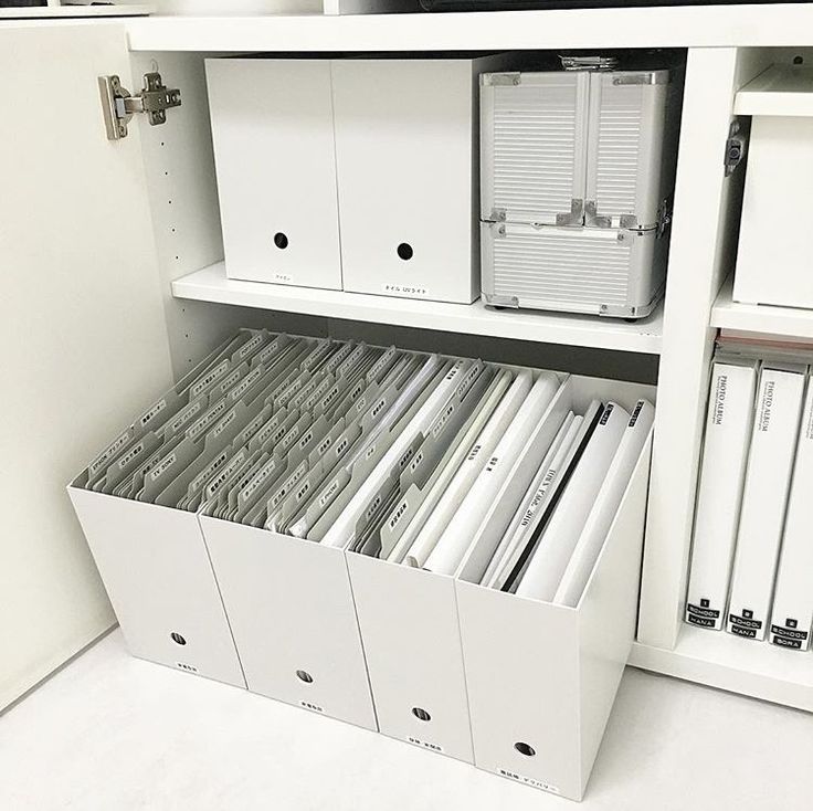 an organized file cabinet filled with files and folders in white, open to reveal the contents