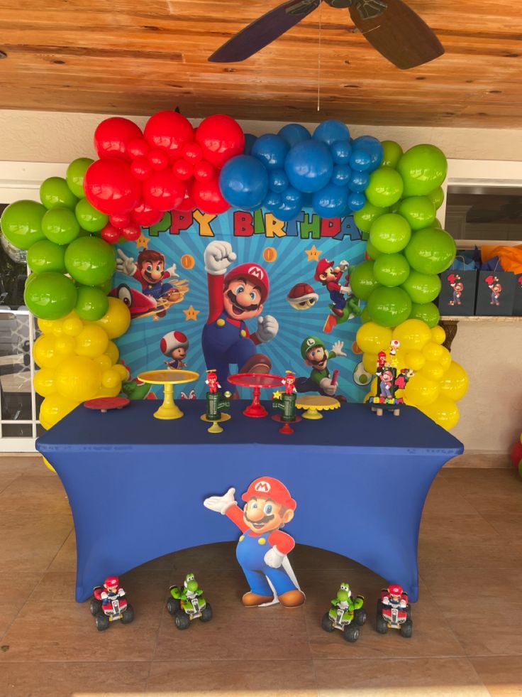 a mario birthday party with balloons and decorations