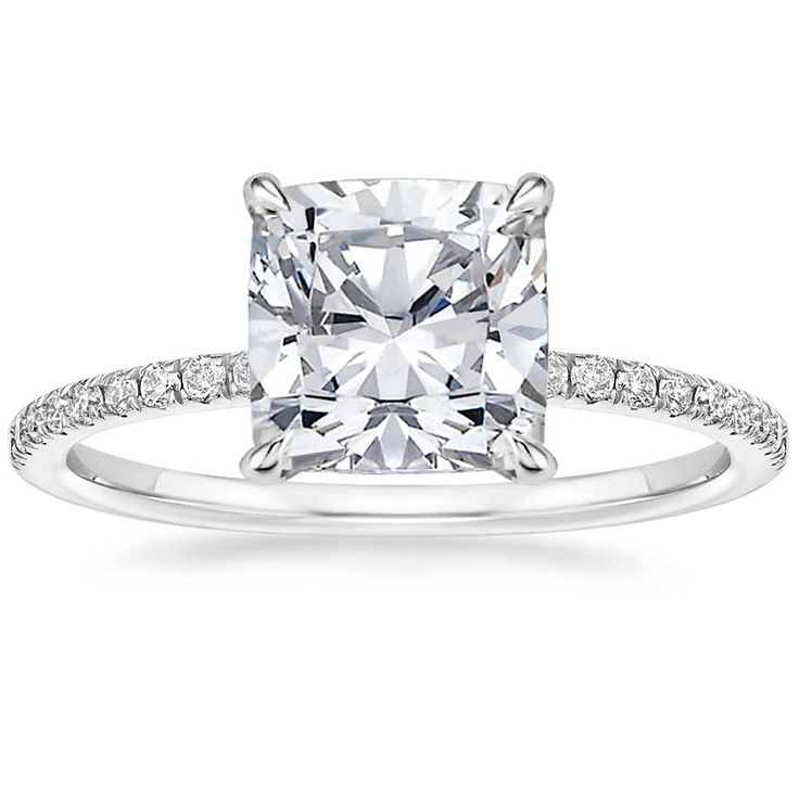 a cushion cut diamond engagement ring with pave set diamonds on the shoulders and sides