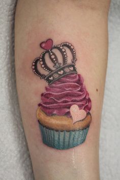 a cupcake with a tiara on it's head and a heart in the middle