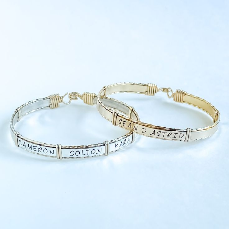 These personalized bracelets are made with .925 sterling silver and high quality 14kt gold-filled wire, making them perfect for everyday wear. With the ability to be personalized with names, dates, astrology signs, paw prints, or even a baby foot symbol, these bracelets can be custom-made to fit any occasion. Mothers and grandmothers love be able to sport children and grandchildren's names, and couples are able to easily fit both names and an anniversary date. Up to seven names generally fit( varies by size and length-of-name, please contact us for specific questions you may have). Classic Adjustable Customizable Jewelry, Personalized 14k Gold Adjustable Bracelets, Everyday Spiritual Jewelry With Custom Name, Personalized Sterling Silver Name Bracelet Bangle, Personalized Sterling Silver Name Bangle, 14k Gold Adjustable Name Bracelet For Personalized Gift, Personalized 14k Gold Adjustable Name Bracelet, Custom Name Silver Bracelet In 14k Gold, Adjustable Hand Stamped Sterling Silver Jewelry