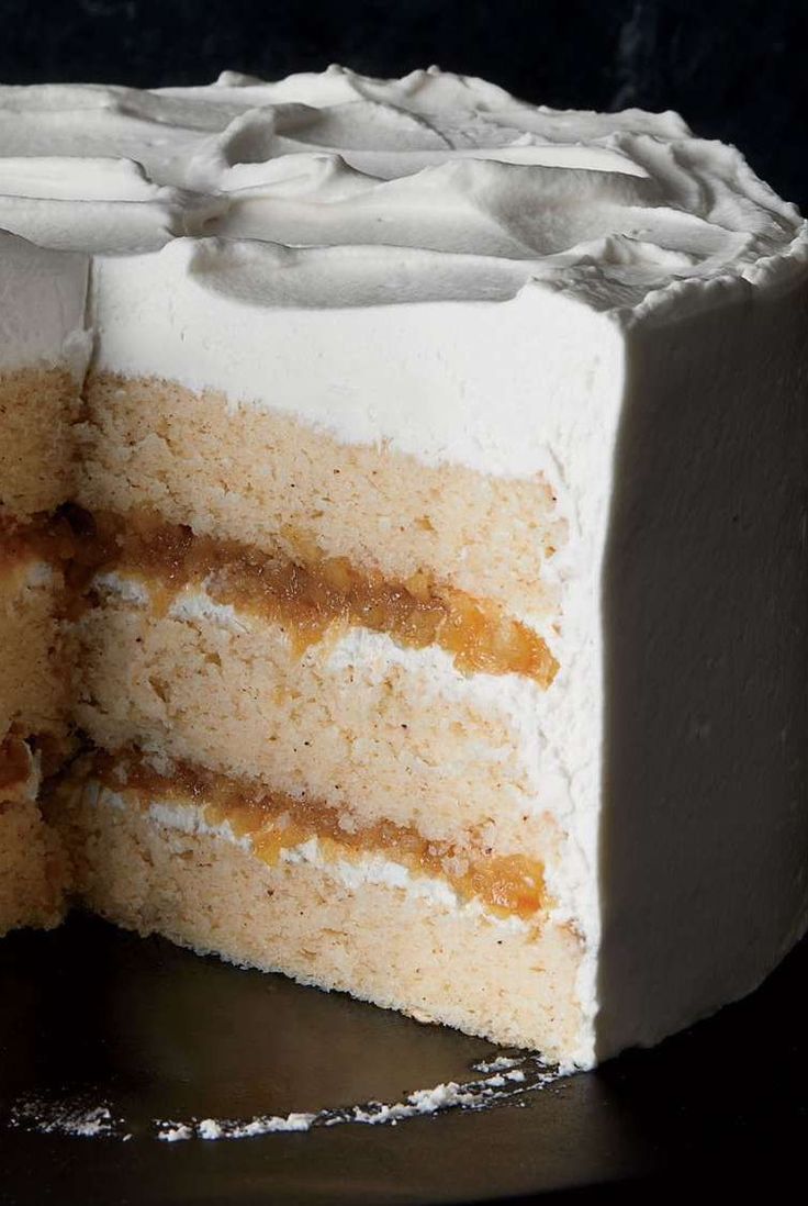 a close up of a slice of cake with frosting on the top and bottom