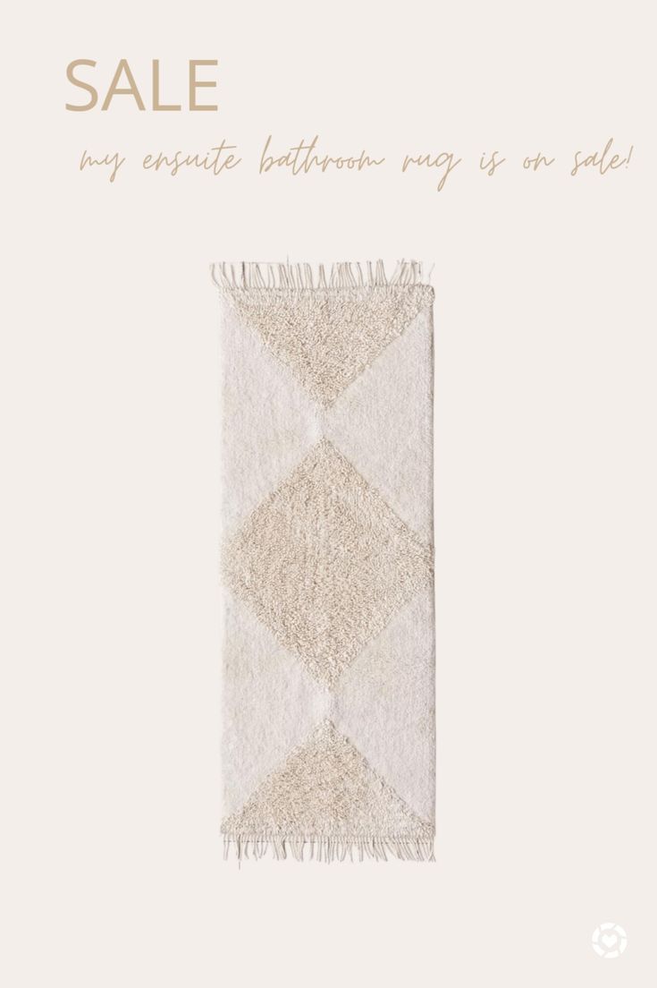 a white rug with fringes on it and the words sale written in gold lettering