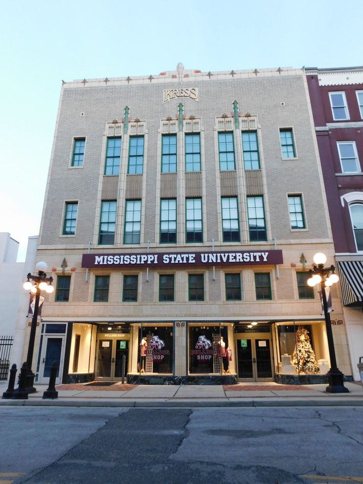 the mississippi state university building is lit up for christmas time in front of it's main entrance