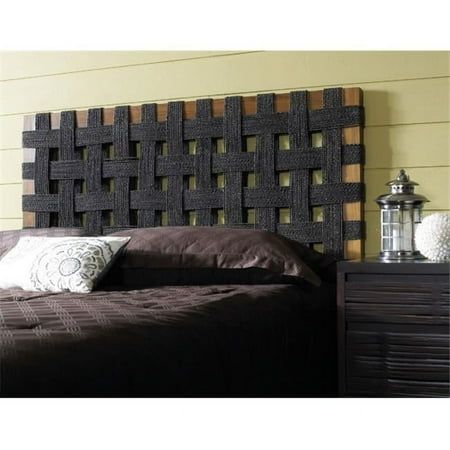 a bed with a headboard made out of wooden blocks and pillows on top of it