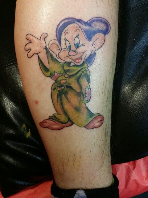 a person with a tattoo on their leg that has an image of a cartoon character