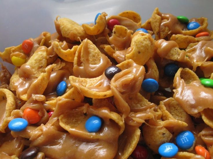 a bowl filled with cereal and candy cornflakes on top of each other,