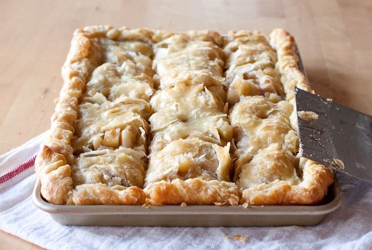 an apple slab pie with a knife in it