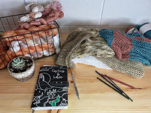 there are many knitting supplies on the table