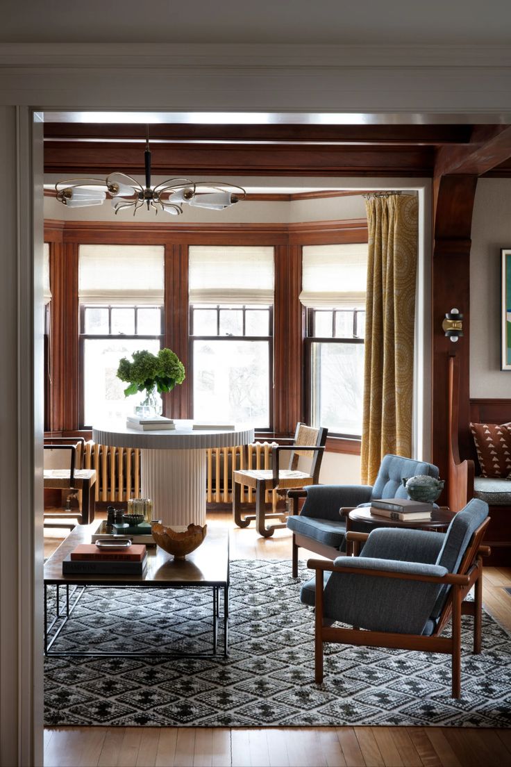 a living room filled with furniture and windows