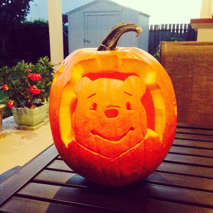 a pumpkin carved to look like winnie the pooh