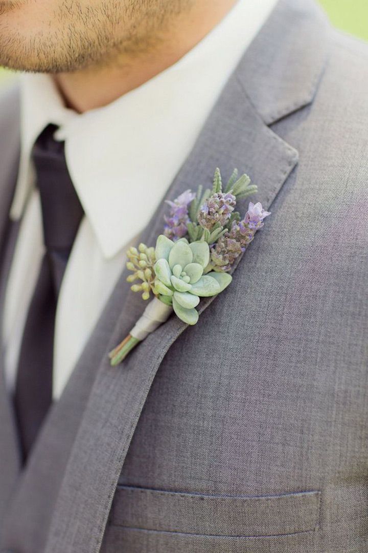 a man wearing a suit and tie with a boutonniere on his lapel