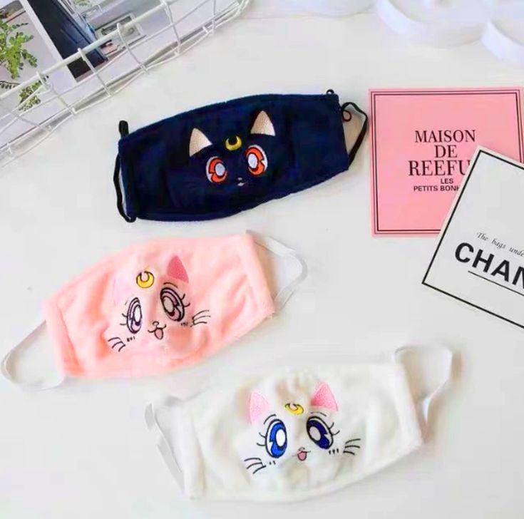 three cat face masks sitting on top of a table