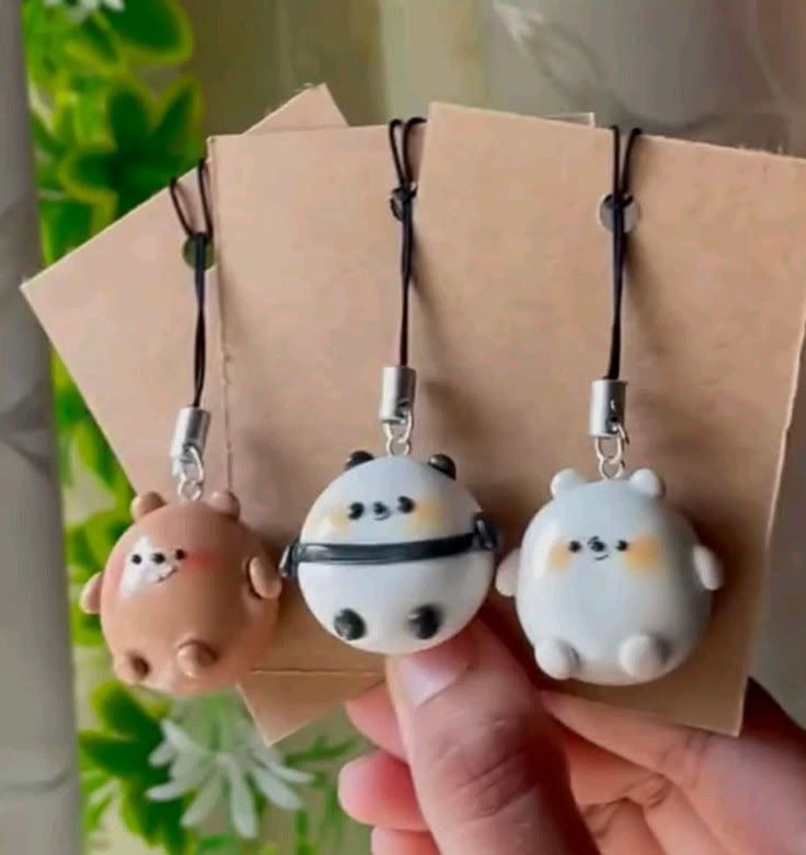 three small animal key chains hanging from a string