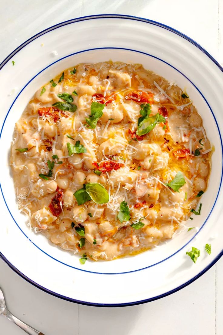 a white bowl filled with pasta and cheese