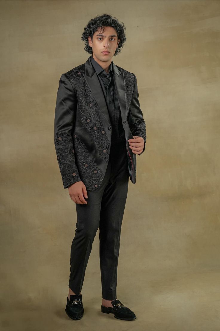 Editor's Note Featuring tone on tone embroidered dire black tux with kat dana details. Paired with a black pintuck shirt and black tapered trousers. Fabric: Linen silk Color: Black Components: Tuxedo, shirt and trousers Occasion: Evening wear Fit: Regular Note: Product colour may slightly vary due to photographic lighting sources Care: Dry clean only About the Designer After establishing himself as the leading couturier in the industry of menswear, Jatin Malik went on to explore luxury footwear. Jatin Malik, Pintuck Shirt, Blouse Yoke, Personal Shopping Service, Tuxedo Shirt, Dhoti Pants, Luxury Footwear, Black Tux, Royal Look