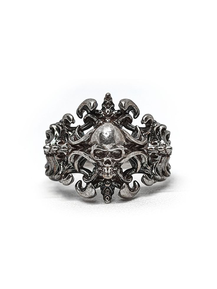 Introducing our exquisite Prince of Darkness Skull Ring perfect for those who love to add a touch of dark glamour to their look. This unique ring features a skeleton crucifix cross engrave into intricate wave pattern inspired by Art Nouveau style.  Crafted from high-quality sterling silver, this ring is the perfect choice for those who love to stand out from the crowd. The intricate detailing of the skulls and fangs is truly exquisite, adding a touch of macabre charm to the overall design. Wheth Silver For Men, Dark Glamour, Prince Of Darkness, Silver Skull Ring, Silver Eye, A Skeleton, Gold Eyes, Art Nouveau Style, Skull Ring