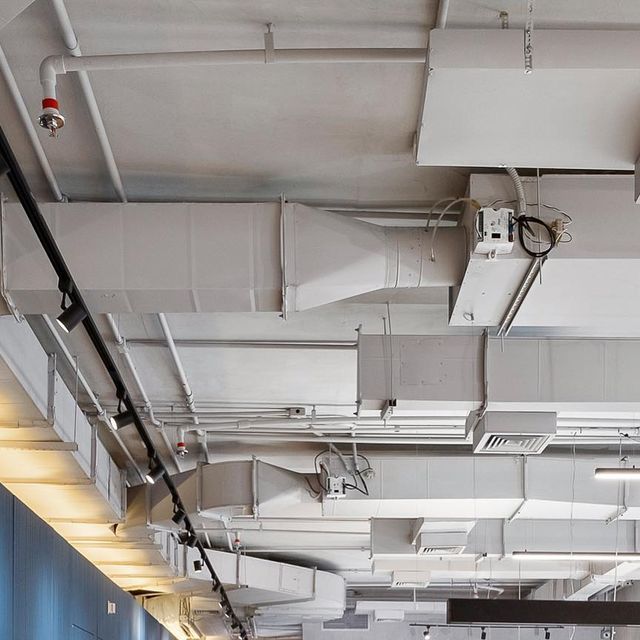 the ceiling in an office building has many lights on it